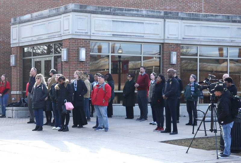 People gather Wednesday, Feb. 14, 2024, for a ceremony in the Peaceful Reflection Garden near Cole Hall honoring the victims of the 2008 shooting at Northern Illinois University in DeKalb. Wednesday marked 16 years since the deadly shooting took place on campus which took the lives of five people.