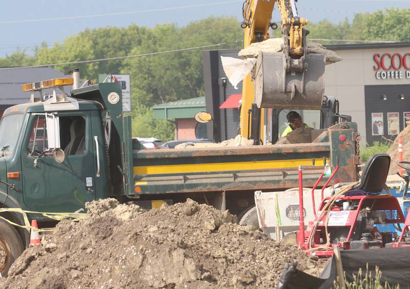 Crews move dirt near the intersection of Backbone Road and North Main Street on Tuesday, July 8, 2025 in Princeton. The foundation of a future Aldi store can be seen in the distance. Work begain on the property beginning in April this year.