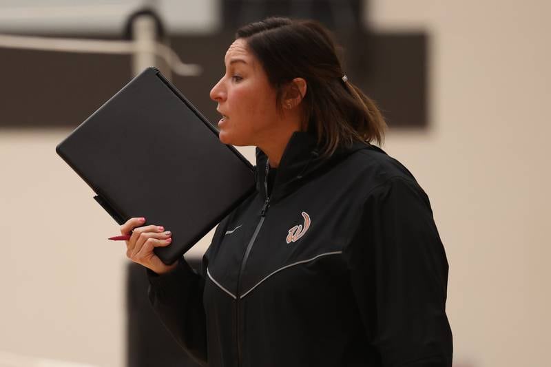 Lincoln-Way West head coach Jodi Frigo talks to her players during the match against Plainfield East on Wednesday, March 22nd. 2023 in New Lenox.