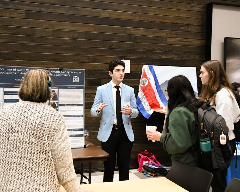Mateo Nery a Columbia University student talks to a few members who attended The Climate of Hope Conference 2024, about renewable energy held at Downers Grove North on Friday March 1, 2024.