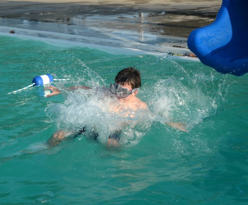 Dennis Fredrichs, 10, of Mt. Morris, splashes into the Polo Pool on Thursday, Aug. 24, 2023. The pool was open from 5-8 p.m. during the recent hot spell to give people a place to cool down.