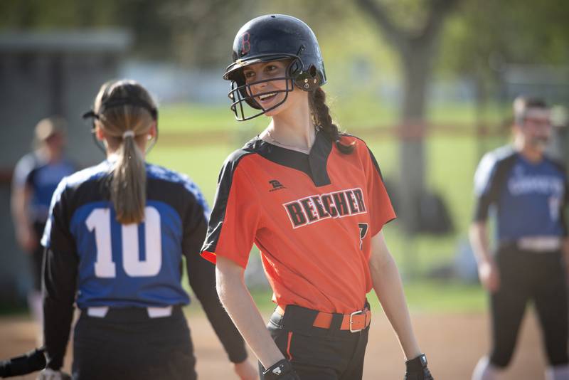 Beecher's Elena Kvasnicka talks with a coach after reaching first on a hit in the fifth inning of a game against Central on April 29, 2025.