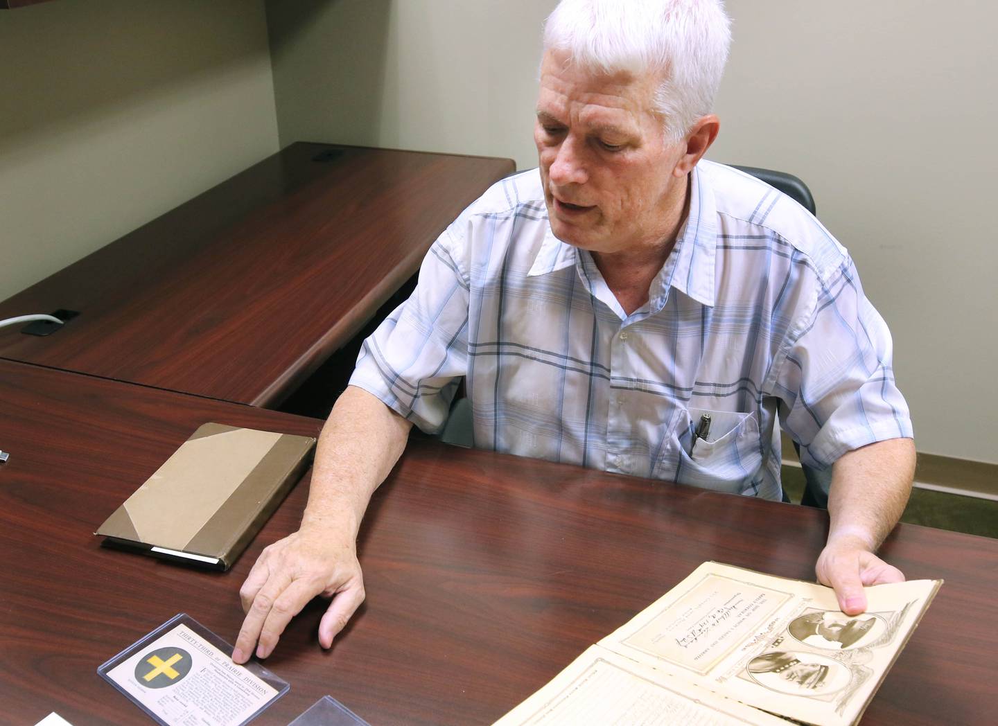 DeKalb resident John Wright talks Monday, Oct. 7, 2024, about some of the items he found in WWI U.S. Army soldier Albert Leonhard’s service record book that he purchased at a local estate sale.