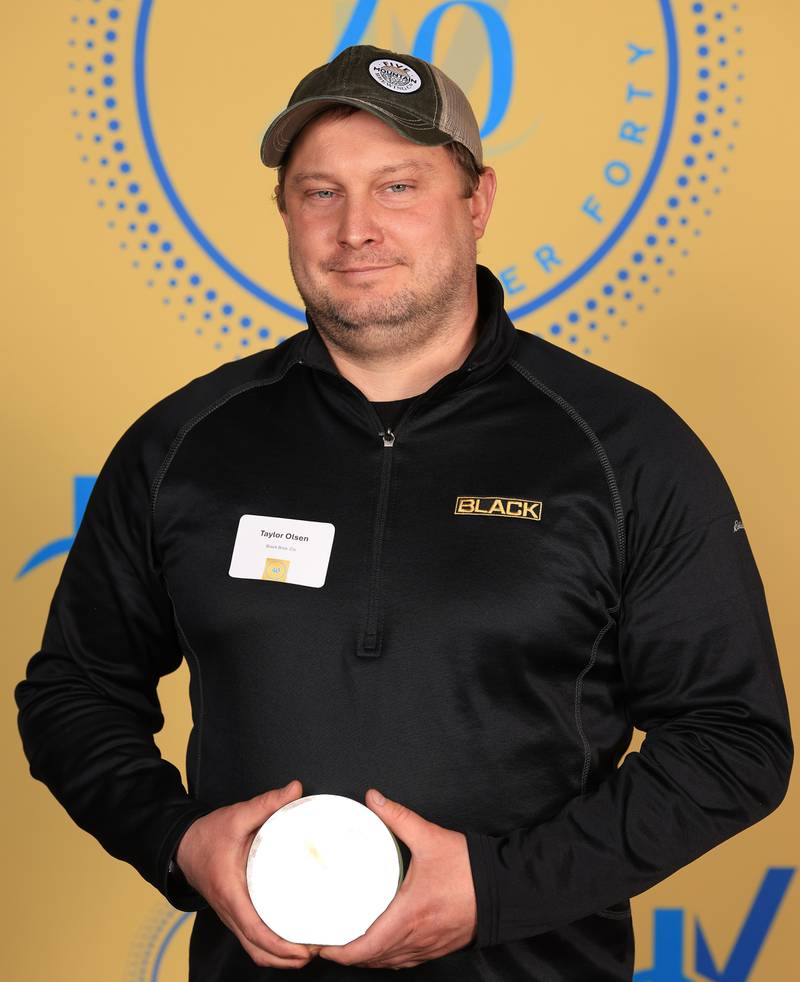 Taylor Olson poses with his 40 Under Forty award during the Illinois Valley Chamber of Commerce Champions of Change Awards Night on Thursday, April 10, 2025 at the Westclox Event Center in Peru.