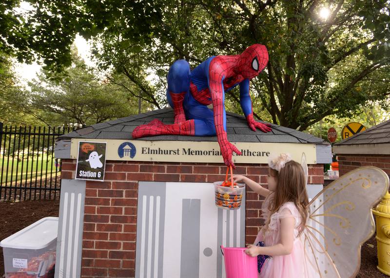 Children including Rory Kirby of Elmhurst receive candy from characters including Spiderman while trick or treating through Safety Town during the Elmhurst Park District Family Fall Fest Saturday, Oct. 5, 2024.