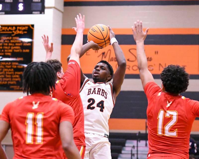 DeKalb's Myles Newman (24) takes a shot while being defended by Jefferson's Jaden Williams (12) and fouled by Jefferson's Alejandro Almonaci (2) during the 3A semifinal regional game on Wednesday Feb. 25, 2026, held at DeKalb High School.