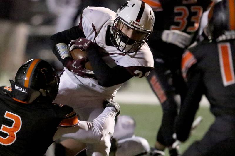 Prairie Ridge's Noah Solis takes the ball over a pile of teammates and McHenry Warriors during their season opening football game at Huntley High School on Friday, March 19, 2021 in Huntley.