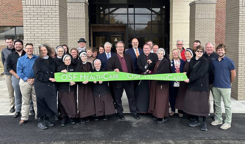 OSF and members of the community conduct a ribbon-cutting ceremony of the main entrance on  inside OSF St. Elizabeth Thursday, Oct. 31, 2024 in Peru. The main entrance is located on the south side of the building.