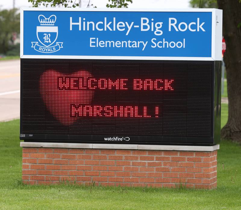 The sign in front of the school welcomes back Marshall Morong, 7, a first grader at Hinckley-Big Rock Elementary School, Monday, May 5, 2025, as he arrives for his first day back following months waiting for, and eventually receiving, heart transplant surgery at Lurie Children’s Hospital of Chicago. Morong arrived in style in a Tesla Cybertruck donated for use by Telsa of Naperville, along with an escort by Hinckley and Big Rock first responders.