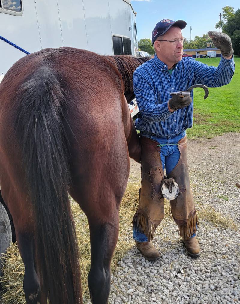 Pontiac's Don Haag, a professional horseshoer, tells the Marquette FFA class the finer points of cleaning a hoof on Friday, Oct. 6, 2023, in Ottawa.