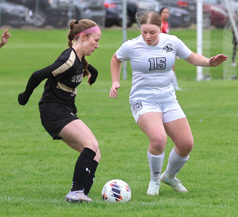 Sycamore's Cortni Kruizenga (left) tries to get the ball past Kaneland's Maya Heller during their game Wednesday, April 29, 2026, at Sycamore High School.