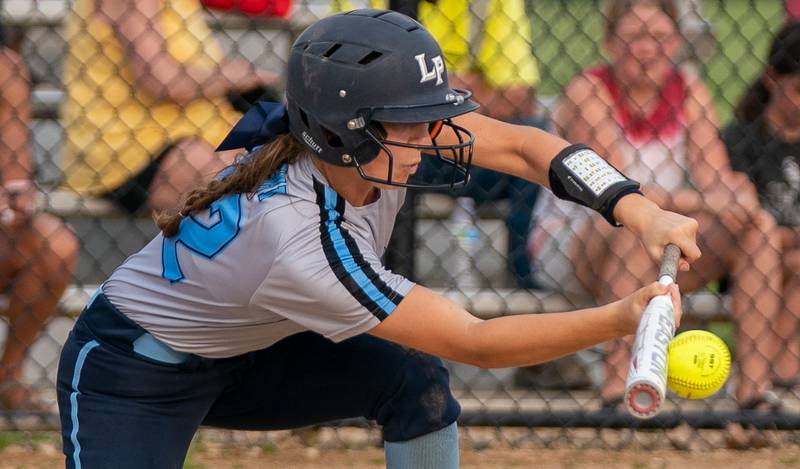 Lake Park's Cailynn Gdowski (22) bunts the ball driving in a run against St. Charles North during a softball game at St. Charles North High School on Wednesday, May 11, 2022.
