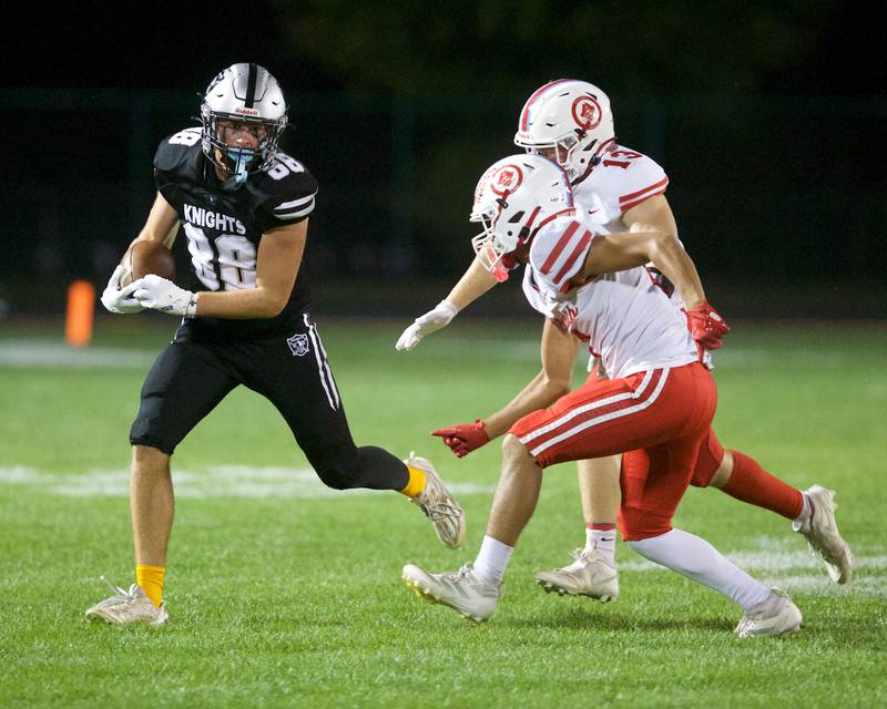 Kaneland's Ryan Majerus looks to avoid the tackle by Ottawa s Ethan Pouture (13) and Bryson Valdez (8) on Friday, Sept. 19, 2025 in Maple Park.