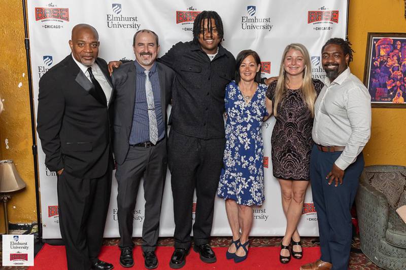 On the red carpet at the “Feel the BASE” premiere are (from left): Eric Davis, co-founder of The BASE; John Klein, assistant professor of digital media at Elmhurst University; Paris Parham, songwriter and The BASE mentor; Christine Grenier, Elmhurst U. vice president for admission; Kristyn Jo Benedyk, associate professor and director of Elmhurst’s digital media program; and Alexander Blumenberg, senior director for community partnerships and first-year admission at Elmhurst U.