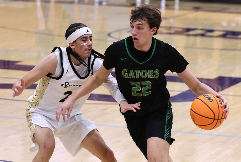 Crystal Lake South's Tony Santarelli drives by Sycamore's Unique Shaw during their sectional semifinal game Tuesday, March 4, 2025, at Rochelle High School.