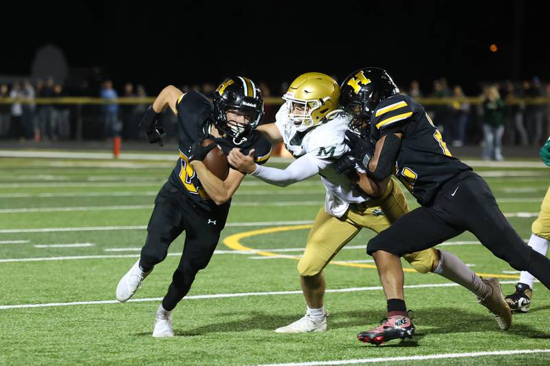 Herscher's Mason Roberts runs off a block by teammate Alek Draper to avoid Bishop McNamara's Karter Krutsinger during the Tigers' 45-28 loss to Bishop McNamara on Friday, Sept. 5, 2025.