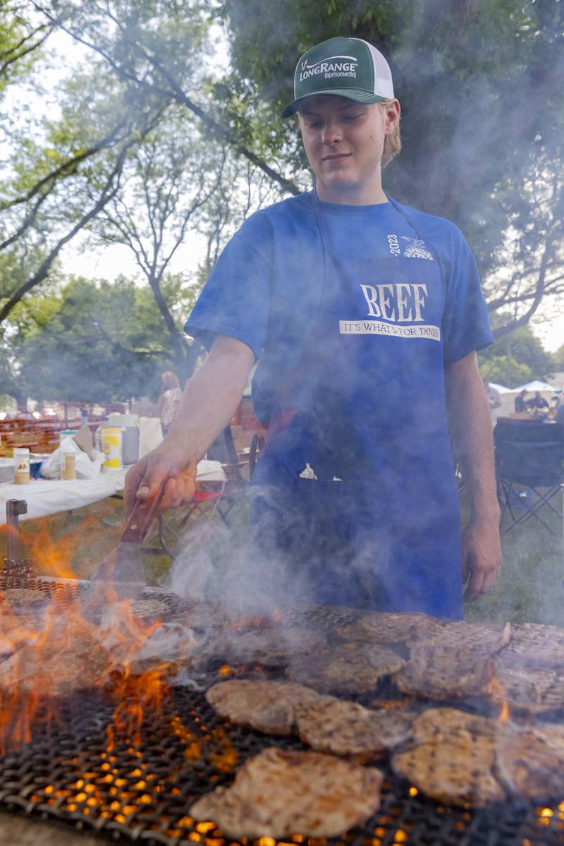 Brody Reviglio mans the grill Saturday, June 15, 2024, during Beef and Ag Days at Soldiers and Sailors Park in Princeton.