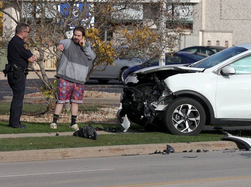 DeKalb County Sherriff Andy Sullivan (left) who was first on the scene, talks to a man at a two vehicle crash Tuesday, Nov. 19, 2024, on Bethany Road near DeKalb Avenue in Sycamore. Both vehicles sustained heavy front end damage.