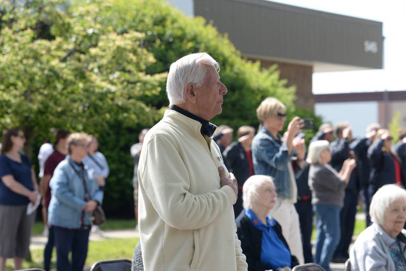 Veterans and community members including Richard Allison honor the flag while the Sounding of Taps is performed during the Memorial Day ceremony held at Veterans Memorial Park Monday May 26, 2025.