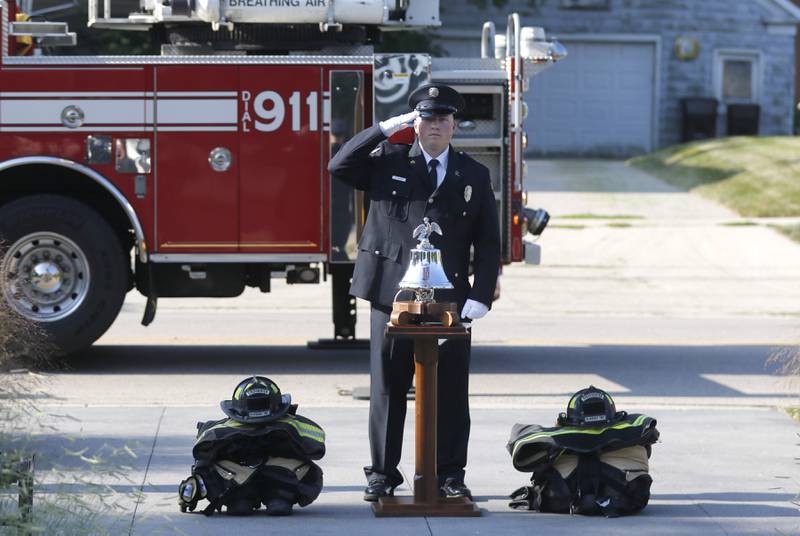 McHenry Township Fire Protection District firefighter Ryan Moore salutes as the flag is raised during a September 11 Remembrance Ceremony on Sept. 11, 2025, at Veterans Park in McHenry.