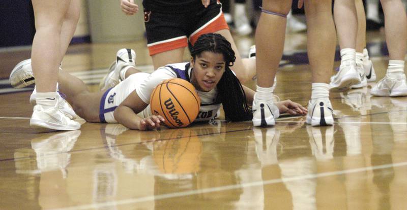 Dixon's Ahmyrie McGowan goes to the floor after a loose ball. The Dixon Duchesses hosted Byron in girls basketball Saturday, Jan. 25, 2025.