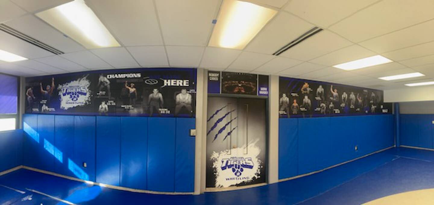 A lineup of new murals of Princeton state medalists adorn the wall of the PHS wrestling room.
