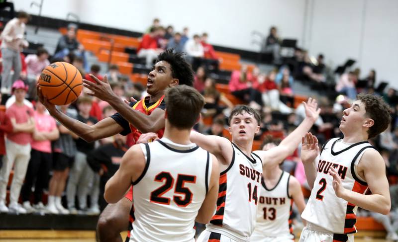 Batavia's Xavier Justice gets a shot up during a game against Wheaton Warrenville South on Friday, Feb. 14, 2025 in Wheaton.