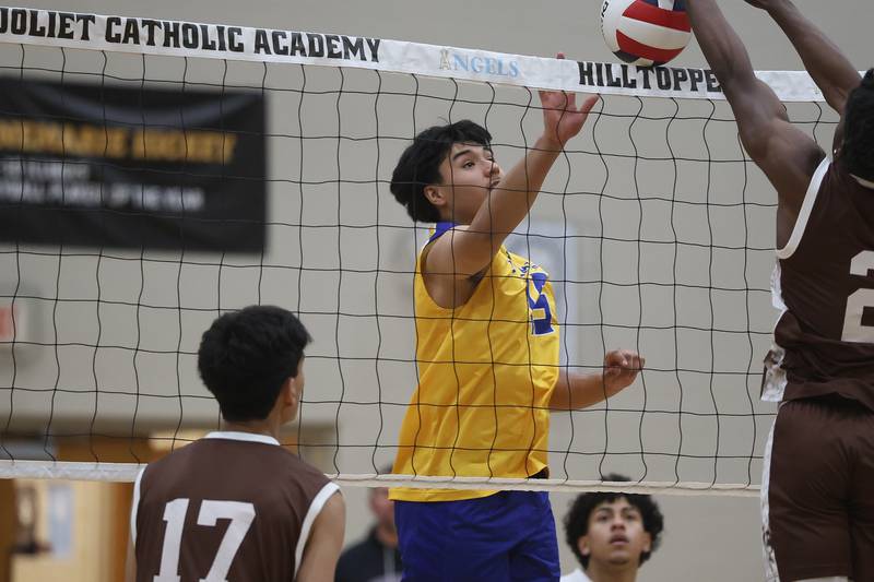 Joliet Central’s Pedro Cornejo pushes over a shot against Joliet Catholic on Wednesday, April 1, 2026 in Joliet.