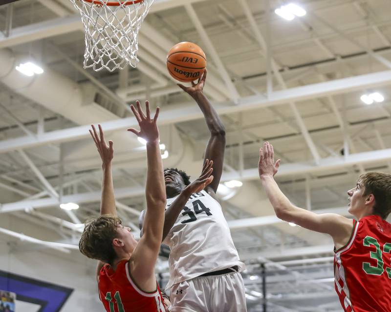 Kaneland's Jeffrey Hassan (34) puts up a shot over the defense during their Plano Christmas Classic semi-final basketball game between Kaneland at LaSalle Peru Monday, Dec 29, 2025 in Plano.