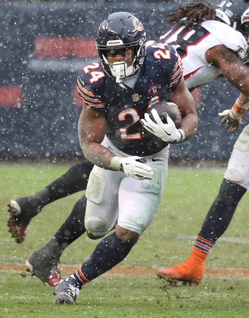 Chicago Bears running back Khalil Herbert finds a hole in the Atlanta Falcons defense during their game Sunday, Dec. 31, 2023, at Soldier Field in Chicago.