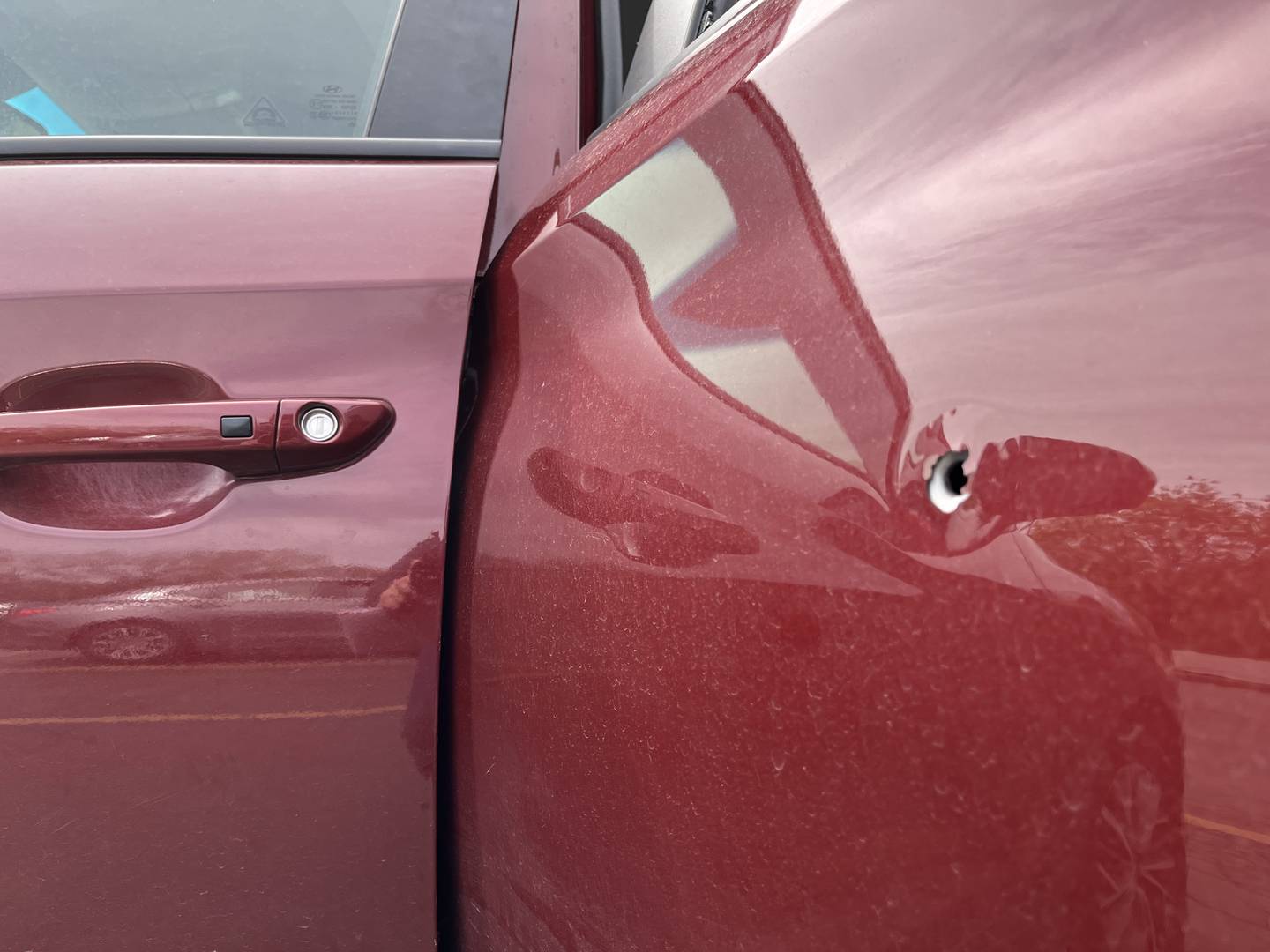 A vehicle damaged by gunfire at the parking lot seen on Thursday, April 18, on Richards Street.