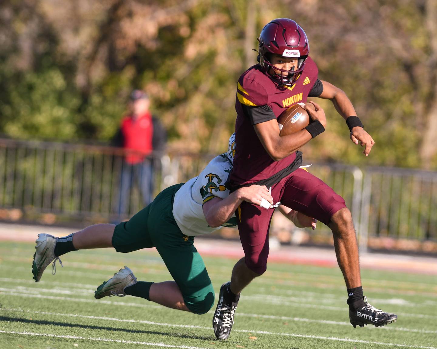 Montini Catholic's Israel Abrams (7) runs the ball before being tripped up by Coal City's Cade Poyner (78) on Saturday Nov. 15, 2025, during the 4A quarterfinals game held at Montini Catholic High School.