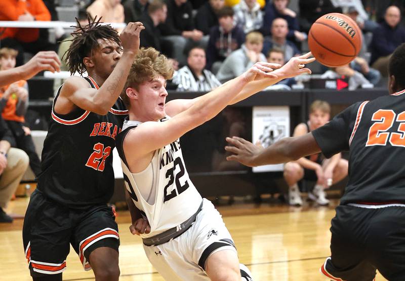 Kaneland's Johnny Spallasso kicks the ball out to a shooter as he drives the lane against DeKalb's Darrell Island during their game Tuesday, Jan. 24, 2023, at Kaneland High School.
