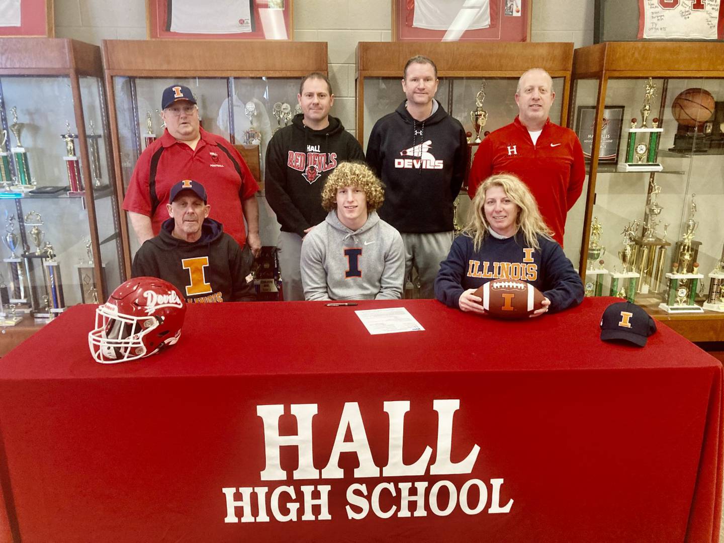 Hall senior Mac Resetich has received a full-ride scholarship offer to play football for the University of Illinois. He is one  of 23 players this year recruited by the Illini this year. He was joined at Wednesday's signing by his parents, Kim Resetich (front) and Betsy Sobin; and Hall coaches (back from left) Randy Tieman, Nick Hanck, Tom Keegan and Mike Filippini.