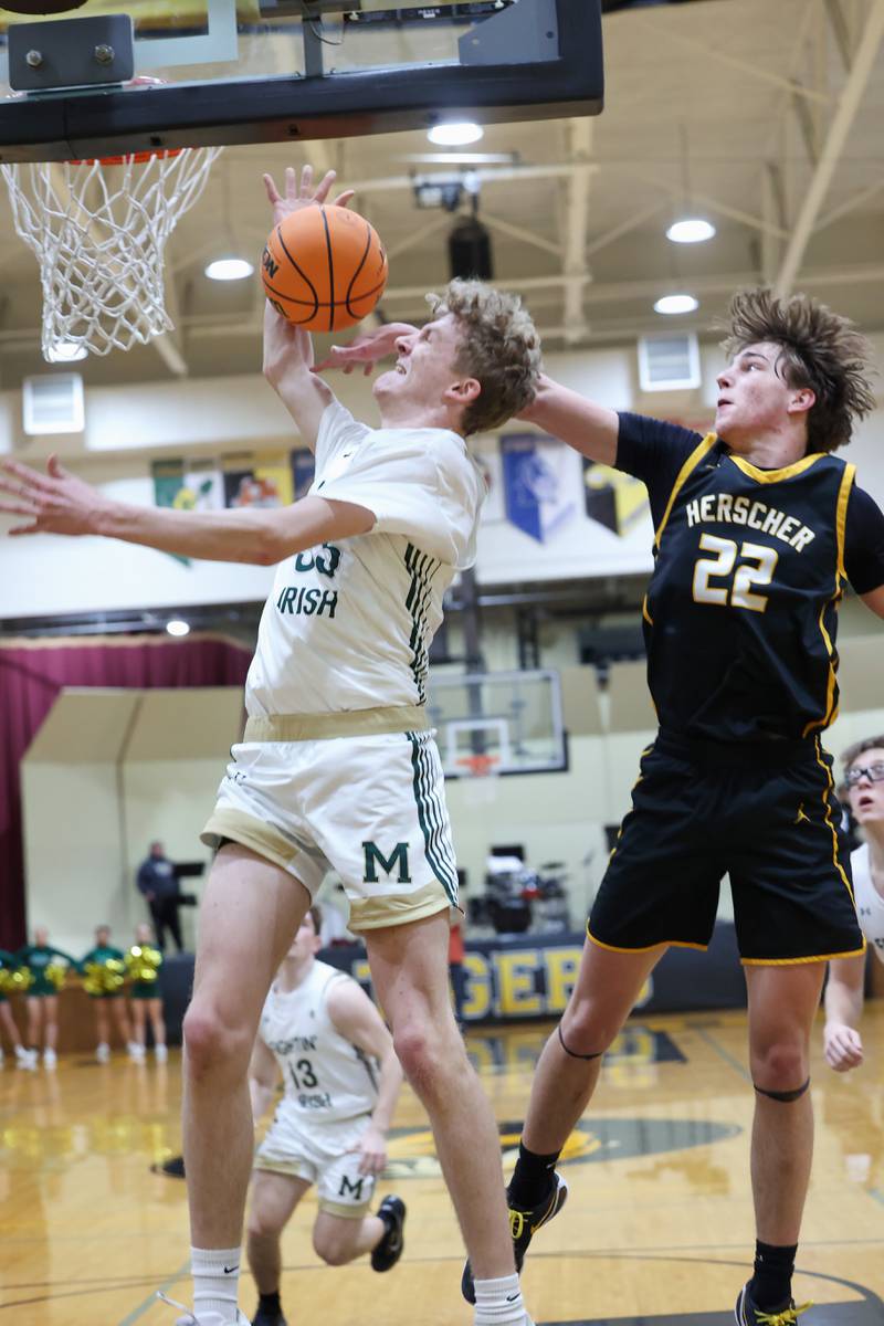 Herscher's Tyler Lundberg knocks the ball away from Bishop McNamara's Richie Darr during Bishop McNamara's 71-42 victory in the IHSA Class 2A Herscher Regional semifinal on Wednesday, Feb. 25, 2026.