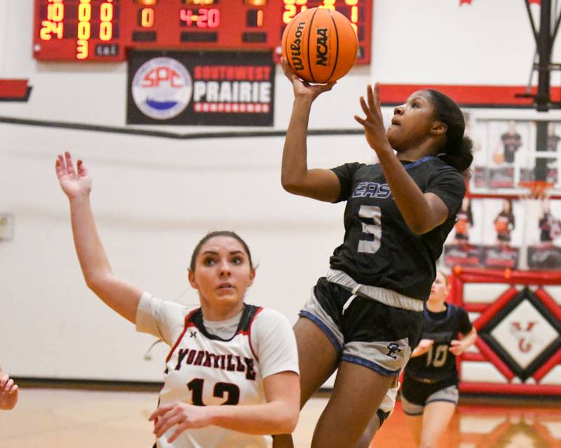 Oswego East's Avaya Kittling-Turner (3) takes a shot while being defended by Yorkville's Hayden Hodges (12) during the game on Thursday Dec. 18, 2025, held at Yorkville High School.