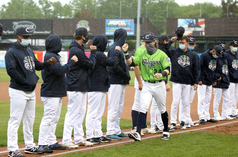 Kane County Cougars player Mark Karaviotis greets his teammates before their home opener against the Chicago Dogs at Northwestern Medicine Field in Geneva on Tuesday, May 18, 2021.