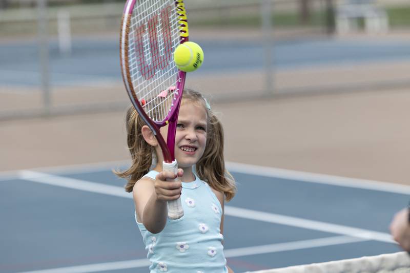 Briella Kemmerer, 5, practices her tennis skills Friday, July 25, 2025, while practicing with dad Dylan.