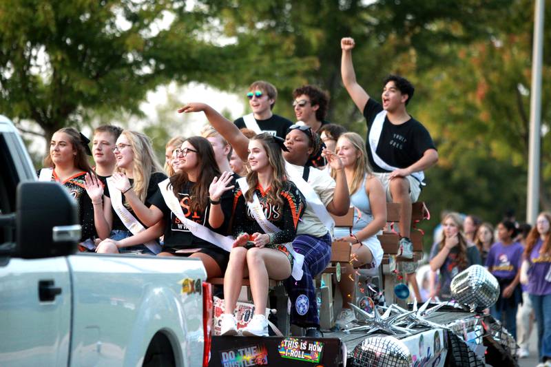 The Wheaton Warrenville South homecoming court rides a float in the school’s annual homecoming parade on Wednesday, Sept. 11, 2024 on Weisbrook Road in Wheaton.