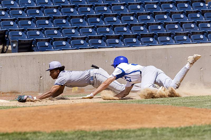 Chicago Hope’s Ezekiel Bonilla dives a tags the bag first for an out ahead of Newman’s Brendan Tunink Monday, May 29, 2023.