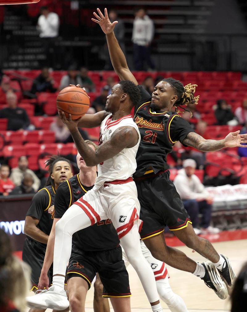 Northern Illinois guard Daemar Kelly goes to the basket ahead of Louisiana-Monroe guard MJ Russell Monday, Nov. 3, 2025, during their game at the Convocation Center at NIU in DeKalb.