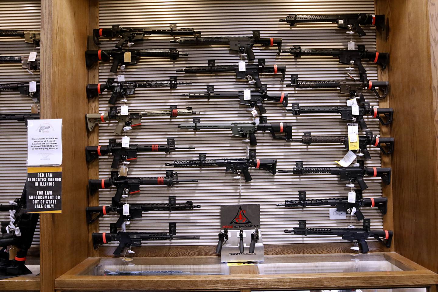Red tagged firearms that can no longer sold at Second Amendment Sports, in McHenry, Wednesday Jan. 11, 2023, after a new gun law restricting a number of firearms and attachments and limiting ammunition was signed into law Tuesday night by Gov. JB Pritzker. The bill, along with requiring registration for such guns if already owned and enhancing gun restraining orders, hits at semiautomatic weapons.