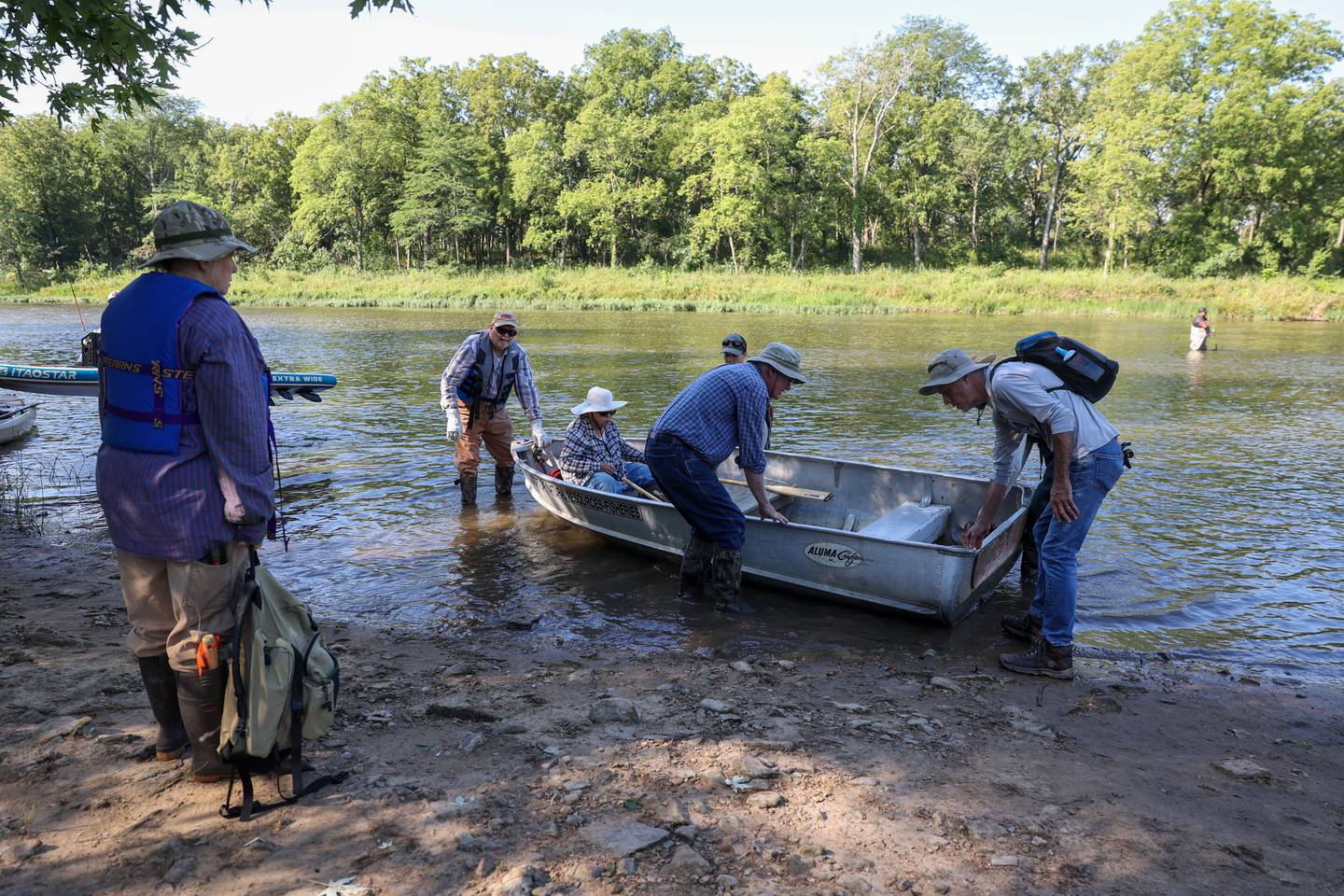 Volunteers prepare to cross the Kankakee River to Langham Island by boat for a Friends of Langham Island stewardship day on Aug. 9, 2025.