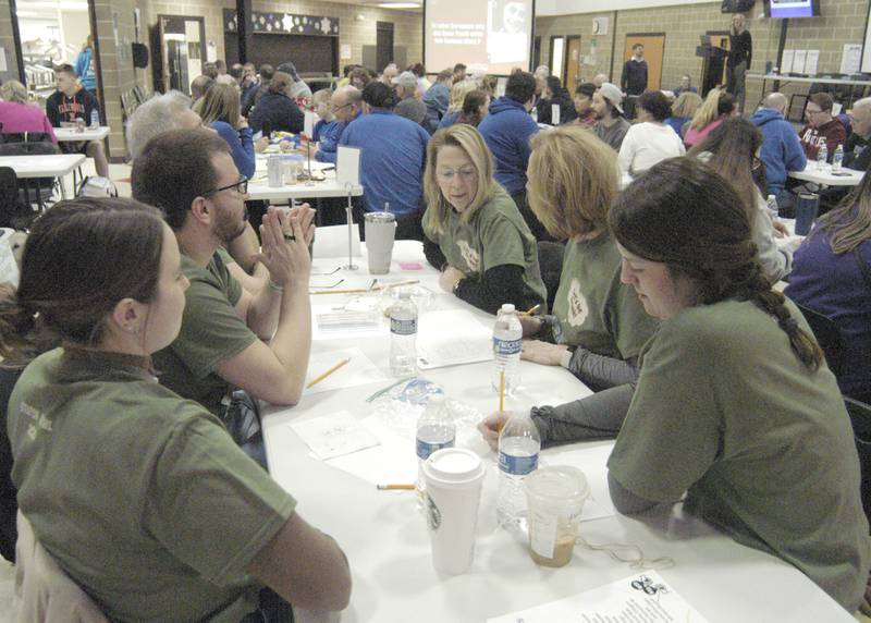 Team "Let's Be Frank" discusses answers at the Stupor Bowl on Saturday, Feb. 8, at Reagan Middle School in Dixon.