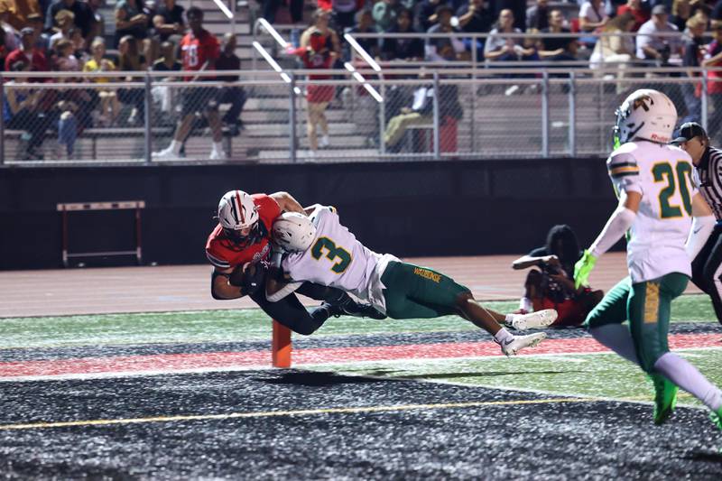 Bradley-Bourbonnais' Calvin Kohl dives into the end zone for a touchdown as Waubonsie Valley's Josiah Griffin attempts to push him out of bounds during the Boilermakers' 35-6 victory over Waubonsie Valley Friday, Sept. 12, 2025.