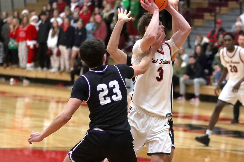 Huntley’s Aidan Gibbs works under the hoop against Hampshire in varsity boys basketball on Friday, Dec. 19, 2025, at Huntley High School in Huntley.