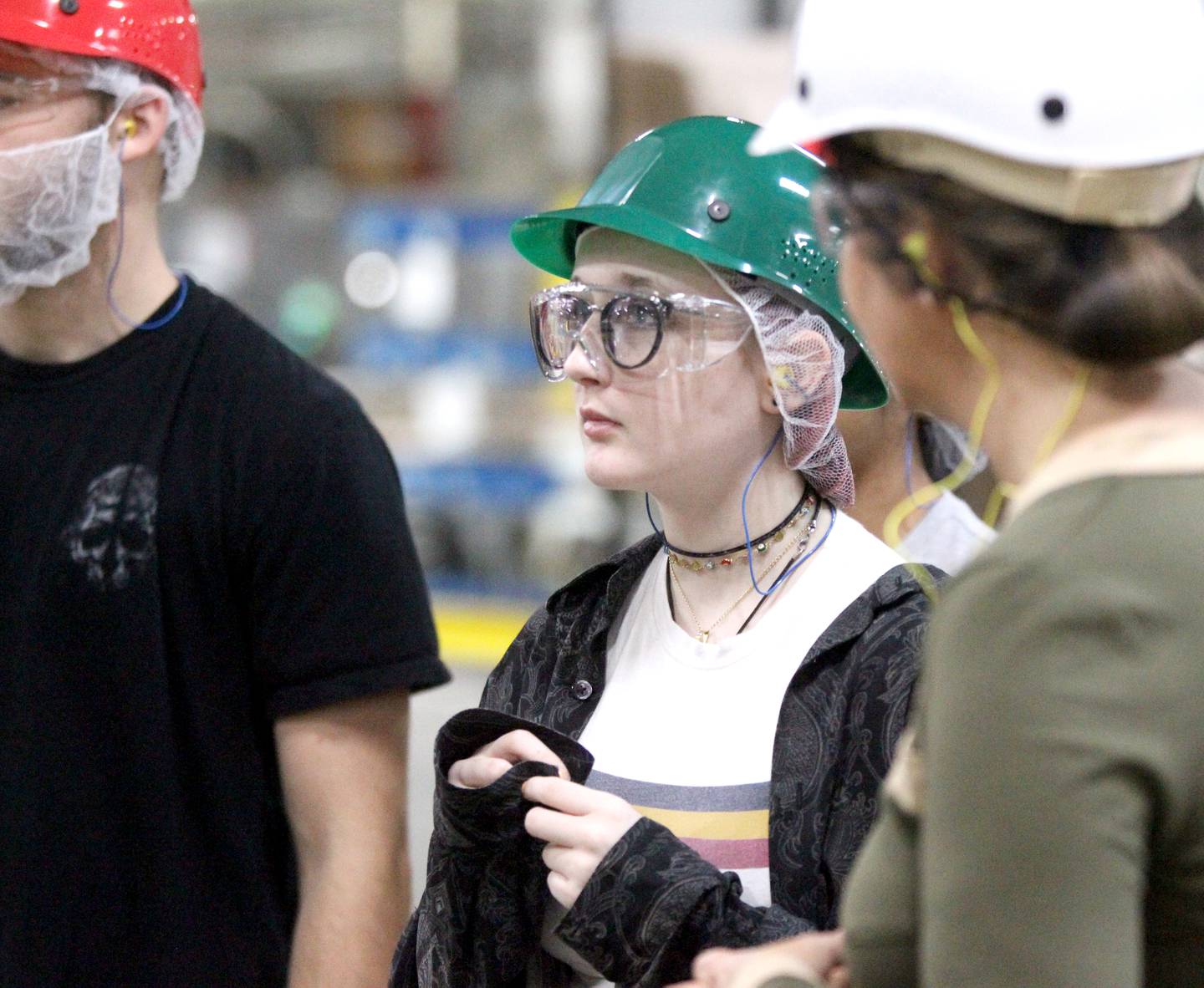 Compass Academy student Max MacPebbles (center) tours the Pactiv Evergreen manufacturing facility in St. Charles on Wednesday, Oct. 26, 2022. Compass Academy is a new St. Charles District 303 program that opened in the fall of 2021 at the Haines Center