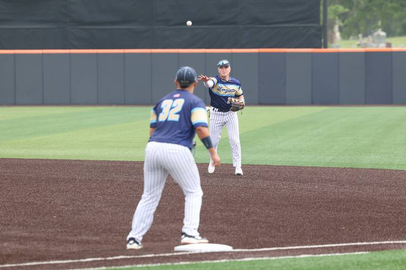 Ottawa Marquette’s Anthony Couch throws to Sam Mitre for the out at first during the Crusaders' 16-1 victory over Lexington in the IHSA Class 1A State semifinal on Friday, June 6, 2025.