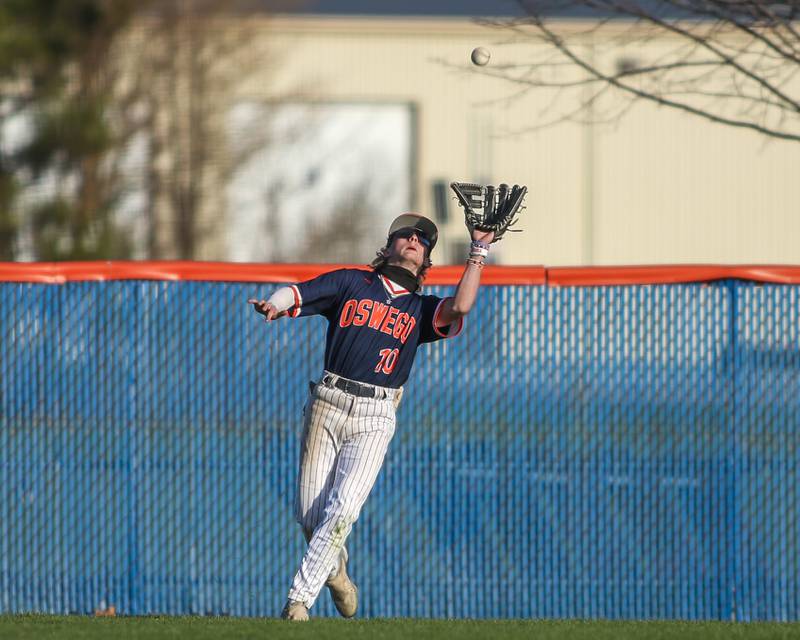 Oswego's TJ Harazin (10) makes a catch in the outfield during baseball game between Plainfield South at Oswego on Monday, April 14, 2025 in Oswego.