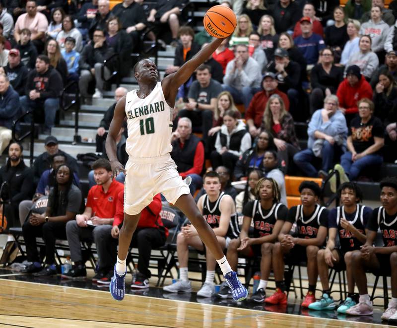Glenbard West's Josh Abushanab reaches for the ball during a Class 4A St. Charles East Sectional semifinal against Glenbard East on Tuesday, March 4, 2025 in St. Charles.